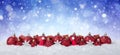 Christmas Background - Decorated Red Balls On Snow with snowflakes and stars Royalty Free Stock Photo