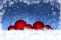 Christmas background decoration with red baubles in snow