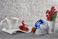 Christmas background with decorations, a cup with a saucer, a ca