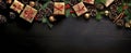 Christmas background with decorations, gifts, pine cones on dark wooden surface. Merry Xmas wishes. Happy New Year. Generative Ai Royalty Free Stock Photo