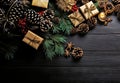 Christmas background with decorations, gifts, pine cones on dark wooden surface. Merry Xmas wishes. Happy New Year. Generative Ai Royalty Free Stock Photo