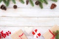 Christmas background with decorations and handmade gift boxes on white wooden board. Royalty Free Stock Photo