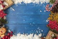 Christmas background with decorations and presents on blue wooden table. Top view with copy space Royalty Free Stock Photo