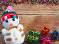 Christmas background decorations with Snowman and gift boxes on the old wood board by Flat lay, top view and copy space Royalty Free Stock Photo