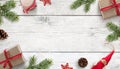 Christmas background with decorations on white wooden surface. Copy space in the middle Royalty Free Stock Photo