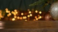 Christmas background. Empty wooden table on the background of the Christmas tree and New Year`s golden bokeh.Ready for product Royalty Free Stock Photo