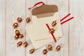 Christmas background.Envelopes with golden acorns.White wooden table.Mokup with empty space