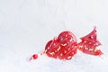 Christmas background - festive red baubles - heart and star with deers print and glow lights inside in shiny white snow.