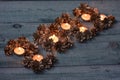 Christmas background of festive silver pine cones in fire burning candles Royalty Free Stock Photo