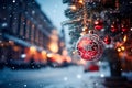 Christmas background with a fir branch with Christmas decorations and a panorama of the festive city in the background