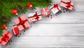 New Year or Christmas background with fir branches and bunch of red gift boxes on white wooden table Royalty Free Stock Photo