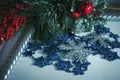 Christmas background with fir branches, cones, a bunch of red berries, candles and snowflakes. Royalty Free Stock Photo