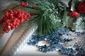 Christmas background with fir branches, cones, a bunch of red berries, candles and snowflakes. Royalty Free Stock Photo