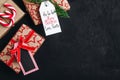 Christmas background with fir branches and a gift box with a red bow on a dark concrete background Royalty Free Stock Photo