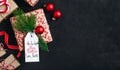 Christmas background with fir branches and a gift box with a red bow on a dark concrete background Royalty Free Stock Photo