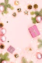 Christmas background with fir branches, lights, purple giftboxes, pink decorations, hot drink with marshmallows on pink Royalty Free Stock Photo