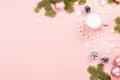 Christmas background with fir branches, lights, red giftboxes, pink decorations, hot drink with marshmallows on pink Royalty Free Stock Photo