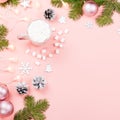 Christmas background with fir branches, lights, red giftboxes, pink decorations, hot drink with marshmallows on pink Royalty Free Stock Photo