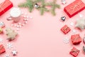 Christmas background with fir branches, lights, red giftboxes, pink decorations, hot drink with snow falling Royalty Free Stock Photo