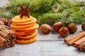 Christmas background with Fir Branches, Nuts, Spices and Dried oranges. Royalty Free Stock Photo