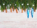 Christmas background with fir branches, snowflakes, toys, cones, cinnamon on brown wooden background Royalty Free Stock Photo