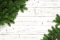 Christmas background with fir branches on white wooden board with copy space. Top view Royalty Free Stock Photo