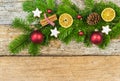 Christmas fir green branch with natural decorations and ornaments on wood background Royalty Free Stock Photo