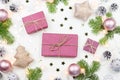 Christmas background with fir tree branches, purple giftboxes, Christmas lights, pink decorations, silver ornaments Royalty Free Stock Photo