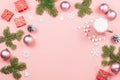 Christmas background with fir tree branches, red giftboxes, pink decorations, hot drink with marshmallows on pink Royalty Free Stock Photo