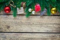 Christmas background with fir tree branches and traditional ornaments on a rustic wooden board. Royalty Free Stock Photo