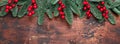 Christmas background with fir tree branches on wooden table. Top view. Horizontal banner. Copy space Royalty Free Stock Photo