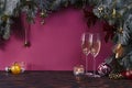 Christmas background with fir tree, champagne in glasses and decoration on dark wooden board, celebration at home Royalty Free Stock Photo