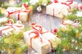 Christmas background with fir tree and decorations and gift boxes on wooden board decorated with snow Royalty Free Stock Photo