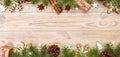 Christmas background with fir tree and gift box on wooden table. Top view banner with copy space for your design Royalty Free Stock Photo