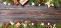 Christmas background with fir tree and gift box on wooden table. Top view banner with copy space for your design Royalty Free Stock Photo