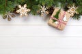 Christmas background with fir tree and gift box on wooden table. Top view with copy space for your design Royalty Free Stock Photo