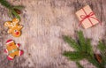 Christmas background with fir tree, gingerbread and a gift on wooden board. Royalty Free Stock Photo