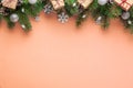 Christmas background with fir tree, holiday decorations, gift boxes on peach fuzz color background. Flat lay. Top view
