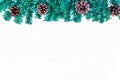 Christmas background with fir tree and pine cones on white table. Top view with copy space Royalty Free Stock Photo