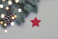 Christmas background. Fir tree on white wooden background with lights and red star Royalty Free Stock Photo