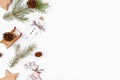 Christmas background of fir twigs, wooden zero waste home decoration: sleigh, cone, reindeer, stars and chistmas tree