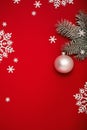 Christmas background with fir, white ball and snowflakes on red. Royalty Free Stock Photo