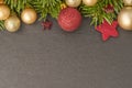 Christmas background with firtree, baubles and stars on slate Royalty Free Stock Photo