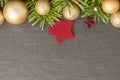 Christmas background with firtree, baubles and stars on slate Royalty Free Stock Photo