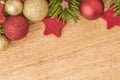 Christmas background with firtree, baubles and stars in wood Royalty Free Stock Photo