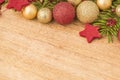 Christmas background with firtree, baubles and stars in wood Royalty Free Stock Photo