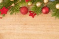 Christmas background with firtree, baubles and stars on wood Royalty Free Stock Photo