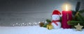 Christmas background with fourth Advent candle and Snowman with red decoration. Royalty Free Stock Photo