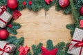 Christmas background frame with fir branches and other decorations presents red stars and bulbs with copy space on wooden table Royalty Free Stock Photo