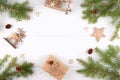 Christmas background frame of fir twigs, wooden zero waste home decoration: reindeer, stars and chistmas tree